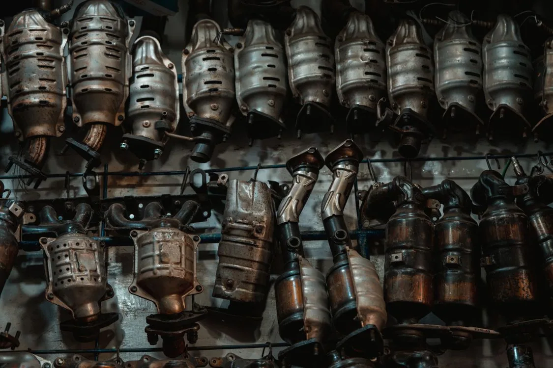 Rows of used catalytic converters in a workshop